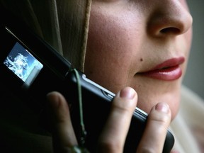 BAGHDAD, IRAQ - JUNE 26: An Iraqi woman uses a mobile phone on June 26, 2008 in Baghdad, Iraq. The war-damaged aging landline telephone infrastructure means Iraqis are increasingly more dependent on mobile phones in daily life and business.  (Photo by Wathiq Khuzaie/Getty Images) ORG XMIT: 81720298