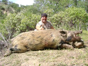 A lucky guy with an unlucky feral boar, somewhere in the U.S. Now you too can shoot pigs in B.C.!