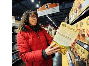 Teresa Lynne, with GE Free BC, holds a box of certified organic and non-GMO cereal at Pomme Natural Market in Port Coquitlam.