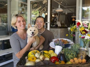 Dara Young and David Gunawan and their dog Gyoza outside of their new restaurant Farmer's Apprentice