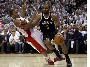 Toronto Raptors guard Kyle Lowry (left) is fouled by Brooklyn Nets guard Alan Anderson during Game 2 of their NBA first-round playoff series at the Air Canada Centre on Tuesday.