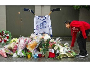 Bantam hockey player Japjot Dhaliwal lays flowers at a memorial for, Julie Paskall