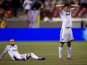 Vancouver Whitecaps Russell Teibert (left) and Omar Salgado look on after losing to Toronto FC in a shootout in the second leg of their Amway Canadian Championship semifinal at BC Place Stadium on Wednesday. (Darryl Dyck, Canadian Press)
