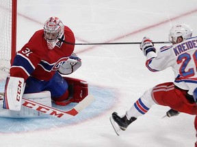 New York Ranger Chris Kreider, skates up, is about to crash into Montreal Canadiens goalie Carey Price during Game 1 of the NHL Eastern Conference Final at Montreal’s Bell Centre on Saturday. (John Kenney, Postmedia News)