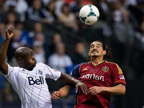 English midfielder Nigel Reo-Coker (left, battling Real Salt Lake’s Devon Sandoval during a MLS game last season at BC Place Stadium) was an important cog in the Vancouver Whitecaps machine in 2013. (Darryl Dyck, Canadian Press files)