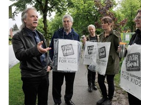 B.C. Teachers Federation president Jim Iker (left) speaks to teachers during a work stoppage by teachers outside Charles Dickens Elementary in Vancouver on May 26, 2014.
