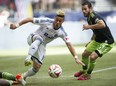 Erik Hurtado moves on the ball, watched by Seattle Sounders' Zach Scott in a 2-2 draw at BC Place