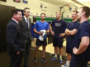 Vancouver Canucks President Trevor Linden introduces new General Manager Jim Benning (L) to players Chris Higgins #20, Alexander Edler #23, Henrik Sedin #33 and Daniel Sedin #22 at Rogers Arena May 23, 2014 in Vancouver, British Columbia, Canada.   (Photo by Jeff Vinnick/ Getty Images)