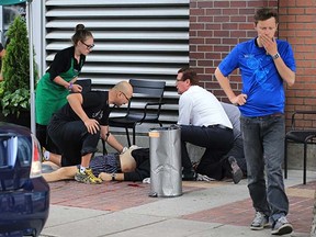 Paul Dragan gets assistance after being shot in Yaletown June 10, 2014