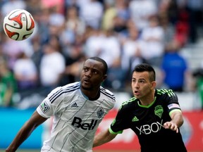 Whitecaps' Nigel Reo-Coker battles Seattle Sounders' Marco Pappa as he fills in at right back.