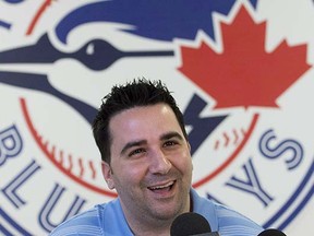 Why is this man smiling? Toronto Blue Jays GM Alex Anthopoulos is a quality baseball man who can see what we all see — that this club needs help. (Nathan Denette, Canadian Press files)