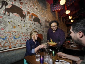 Vikram Vij (centre) and diners Taryn Zimmer and Tom Lewis)