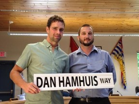 Dan Hamhuis, his sign, and Dave Tucker of the Smithers Minor Hockey Association.