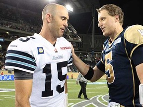Quarterbacks Ricky Ray (left) and Drew Willy meet after the last time the Toronto Argonauts and Winnipeg Blue Bombers faced each other, a 45-21 Bombers victory on June 26 in Winnipeg. (Marianne Helm, Getty Images)