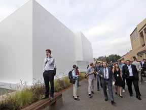 Guests arrive for the start of an Apple event on Tuesday, Sept. 9, 2014, in Cupertino, Calif. Along with larger iPhones, Apple is poised to unveil a wearable device  marking its first major entry in a new product category since the iPad's debut in 2010.