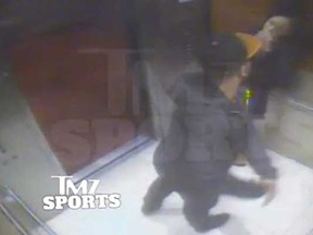 In this still image taken from a hotel security video released by TMZ Sports, Baltimore Ravens running back Ray Rice punches his fiancee, Janay Palmer, in an elevator at the Revel casino in Atlantic City, N.J., in February 2014. (Associated Press)