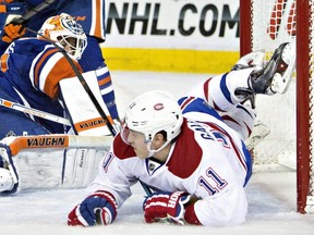 Montreal Canadiens Brendan Gallagher (11) crashes into Edmonton Oilers goalie Ben Scrivens during the first period of an NHL hockey game in Edmonton, Alberta, on Monday.