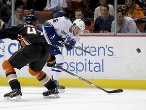 Vancouver Canucks winger Nicklas Jensen shoots around Anaheim Ducks defenceman Hampus Lindholm during the first period of the Nov. 9, 2014 NHL game in Anaheim, Calif. (Chris Carlson, Associated Press)