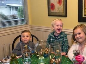 Banks, 6, Jake 2, and Maya, 8, have fun doing indoor garden projects