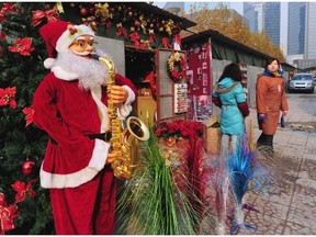 A Chinese university has banned Christmas, especially common displays such as this  - Santa playing saxophone. A B.C. poll shows ethnic Chinese in the province have differences and similarities when it comes to this big seasonal festival.