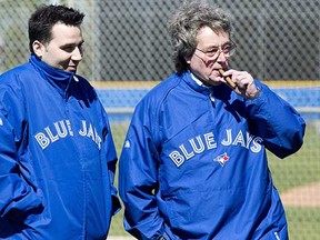 Toronto Blue Jays President and CEO Paul Beeston (right) with general manager Alex Anthopoulos talk at Jays spring training in Dunedin, Fla., last February. (Nathan Denette, Canadian Press files)