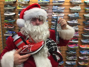 Santa dropped in early to the Sumas Way Running Room on Monday to show off the new medal that every finisher in the 5K Santa Shuffle and 1K Elf Walk will receive this Saturday in Abbotsford. Asked if he's been training he said "Ho Ho Ho."