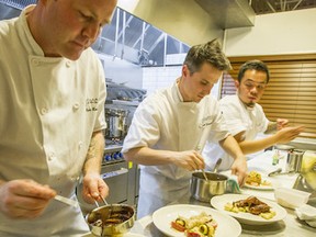 - Chef Ryan Reed, left and Chef Scott Swanson, centre plate dishes in their kitchen at Nomad