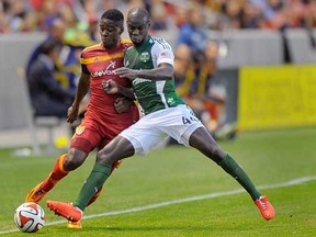 Pa Modou Kah (right) of the Portland Timbers leans on Olmes Garcia of Real Salt Lake during an April 2014 Major League Soccer game in Sandy, Utah. Kah signed with the Vancouver Whitecaps on Wednesday. (Gene Sweeney Jr., Getty Images)