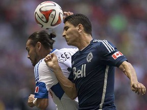 Vancouver Whitecaps centre back Johnny Leveron (right) in action against the Montreal Impact's Issey Nakajima-Farran during a June 2014 MLS game at BC Place Stadium. (Darryl Dyck, Canadian Press)