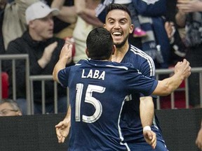 Vancouver Whitecaps Pedro Morales celebrates his goal with Matias Laba against San Jose Earthquakes in MLS action Saturday, May 3, 2014, at B.C. Place in Vancouver, B.C.