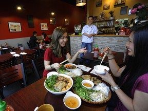 Vancouver  B.C.   February 10, 2015   Authentic Vietnamese flare-- Dinners enjoy the unique tastes inside Mr. Red vietnamese restaurant in Vancouver February 10, 2015.
(Florence Le (left)  Rose  Nguyen (r)
chef  Hong Duong  (back looking out)

Mark van Manen /PNG Staff
Photographer

see Mia Stainsby  Vancouver Sun/ review and feature / stories and WEB

00034608A