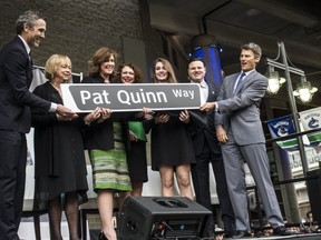 Mayor Gregor Robertson, Canucks Trevor Linden and the family of hockey great Pat Quinn unveil Pat Quinn Way sign on March 17,  2015. (Steve Bosch / PNG staff photo)