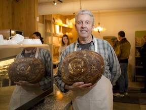 Chris Brown, co-owner and head baker holds up a miche at Batard Boulangerie Cafe Moderne