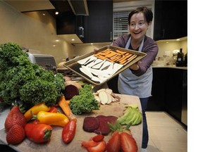 Caitlin Adam uses lots of fresh organic vegetables preparing dinner and veggie chips in Vancouver on March 11, 2015. She buys organic as much as she can within her family budget.
Photograph by: Mark van Manen , PNG