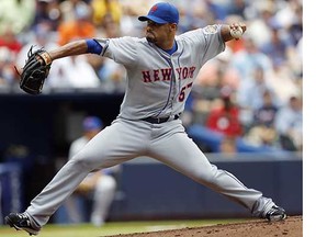 Then-New York Mets starting pitcher Johan Santana delivers to the plate during a July 2012 National League game. The Toronto Blue Jays have signed the two-time Cy Young winner to a minor-league contract, hoping the former ace can make it back to the majors. (John Bazemore, Associated Press files)