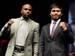 Boxers Manny Pacquiao (R) from the Philippines and Floyd Mayweather from the US pose during a press conference on March 11, 2015 in Los Angeles, California, to launch the countdown to their May 2, 2015 super-fight in Las Vegas.  FREDERIC J. BROWN/AFP/Getty Images