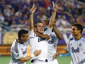 Whitecaps striker Octavio Rivero points skyward, celebrating his extra-time goal against host Orlando City SC in their Major League Soccer game on Saturday, March 21, 2015. (Reinhold Matay, USA Today Sports)
