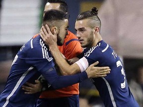 Pedro Morales (left) needs his teammates to pitch in for his style of play to thrive, while fellow midfielder Russell Teibert (right) is becoming an essential perfumer for the Whitecaps. (Elaine Thompson, Associated Press files)