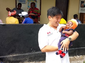 Doug and a child that was delivered at one of our health events.