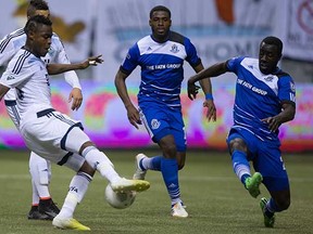 Vancouver Whitecaps midfielder Gershon Koffie (left) somewhat redeemed himself with this late second-half goal that rescued a 1-1 draw against FC Edmonton on Wednesday at BC Place Stadium. (Darryl Dyck, Canadian Press)