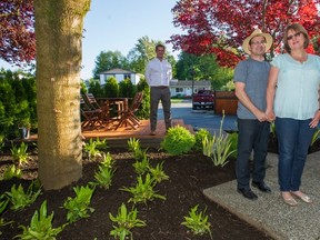 Anna and Mike Towle with Ryan Donohoe in the background in their new "gift garden