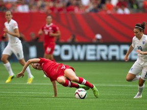 Canada's Lauren Sesselmann, left, misplays the ball as England's Jodie Taylor (19) gets ready to move towards the Canadian goal during first half FIFA Women's World Cup quarter-final soccer action in Vancouver, B.C., on Saturday June 27, 2015.