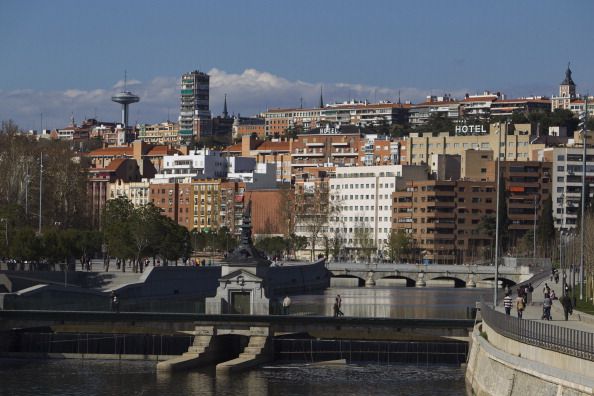 Residential properties stand near the Manzanares river in Madrid, Spain, on Saturday, April 7, 2012. Spanish Prime Minister Mariano Rajoy stepped up efforts to reassure investors he can bring the Country's deficit under control as his government fights to avoid becoming the fourth euro-area member to require a bailout. Photographer: Angel Navarrete/Bloomberg via Getty Images