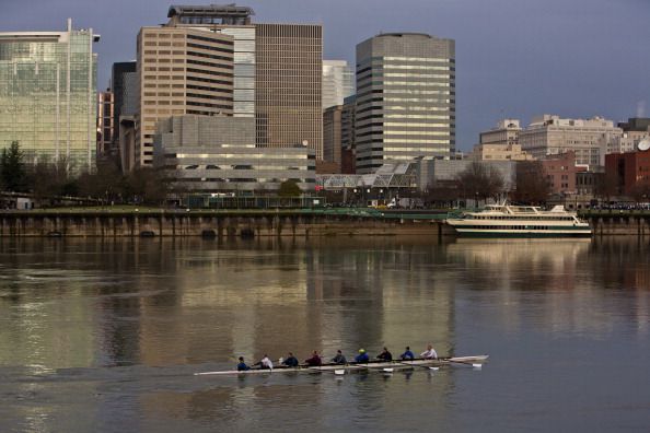 PORTLAND, OR - FEBRUARY 11:  A rowing crew glides past the downtown skyline on February 11, 2012, in Portland, Oregon.  Portland has embraced its national reputation as a city inhabited with weird, independent people, as underscored by the dark comedy of the IFC TV show "Portlandia." (Photo by George Rose/Getty Images)