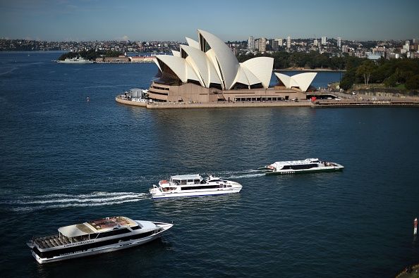 Passenger boats sail towards the Circular Quay ferry terminal in front of Sydney's Opera House on May 27, 2015. According to an infrastructure audit report released last week, Australia must pour more money into transport systems or risk gridlock in its biggest cities costing more than 42 billion USD a year. AFP PHOTO / Saeed Khan        (Photo credit should read SAEED KHAN/AFP/Getty Images)