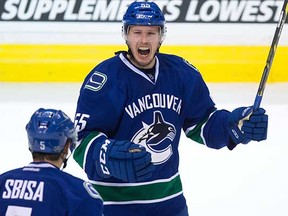 Alex Biega celebrates his first career NHL goal last season, scoring for the Vancouver Canucks against the visiting Minnesota Wild at Rogers Arena. (Darryl Dyck, Canadian Press)