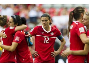 Canada's Christine Sinclair stands alone as her teammates hug after losing 2-1 to England in their FIFA Women’s World Cup quarter-final game at BC Place Stadium on Saturday. (Gerry Kahrmann, PNG)