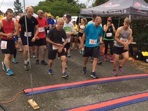 Ryan Prachnau of Abbotsford, on the right wearing bib No. 86, starts his stopwatch as the 12th annual Fort Langley Half-Marathon and 5K race gets underway Sunday morning. Prachnau became a back-to-back champion with his 1:17.13 clocking, finishing more than six minutes ahead of the runner-up.