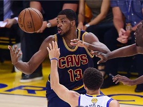 Tristan Thompson of the Cleveland Cavaliers (left) vies for a loose ball against Golden State Warriors defenders during the NBA Final in June. (Frederic J. Brown, AFP/Getty Images)
