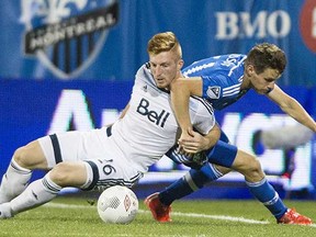 Vancouver Whitecap Tim Parker (left), vying with the Montreal Impact’s Maxim Tissot for the ball, was yet again impressive in defence. (Graham Hughes, Canadian Press)